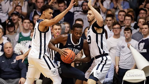 Villanova forward Dhamir Cosby-Roundtree (21) cuts between Butler forward Jordan Tucker (1) and forward Bryce Golden (33) in the second half of an NCAA college basketball game in Indianapolis, Tuesday, Jan. 22, 2019. Villanova defeated Butler 80-72. (AP Photo/Michael Conroy)