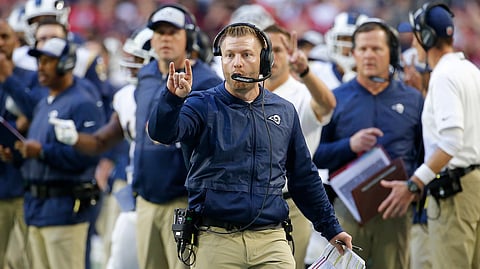 FILE - In this Sunday, Dec. 23, 2018 file photo, Los Angeles Rams head coach Sean McVay makes a call against the Arizona Cardinals during the second half of an NFL football game in Glendale, Ariz. Two years to the day after McVay became the youngest head coach in modern NFL history, he will attempt to earn his first playoff victory Saturday night when the Rams (13-3) host the Dallas Cowboys (11-6) for a trip to the NFC championship game. The Rams already have won 24 games and two NFC West titles under McVay, and they’re just two more victories away from their first Super Bowl trip in 17 years. (AP Photo/Rick Scuteri, File)