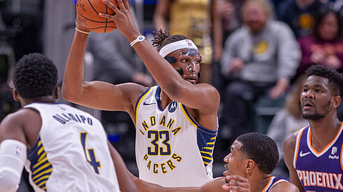 Indiana Pacers center Myles Turner (33) keeps the ball from Phoenix Suns’ De’Anthony Melton (14) during the first half of an NBA basketball game Tuesday, Jan. 15, 2019, in Indianapolis. (AP Photo/Doug McSchooler)