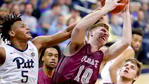 Colgate’s Will Rayman (10) gets a rebound in front of Pittsburgh’s Au’Diese Toney (5) during the first half of an NCAA college basketball game, Saturday, Dec. 29, 2018, in Pittsburgh. (AP Photo/Keith Srakocic)