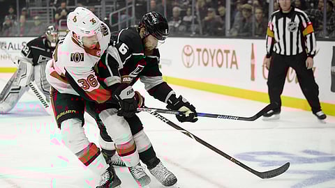 Ottawa Senators center Colin White, center, and Los Angeles Kings defenseman Jake Muzzin, right, battle for the puck as Kings goaltender Jonathan Quick watches during the first period of an NHL hockey game Thursday, Jan. 10, 2019, in Los Angeles. (AP Photo/Mark J. Terrill)