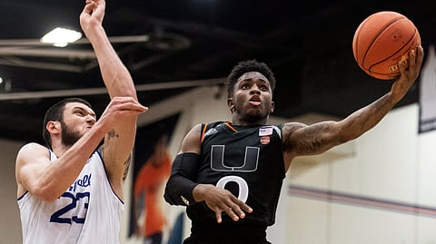FILE - In this Sunday, Nov. 25, 2018, file photo, Miami guard Chris Lykes, right, goes to the basket past Seton Hall forward Sandro Mamukelashvili during the second half of an NCAA college basketball final game at the Wooden Legacy tournament in Fullerton, Calif. Lykes, the Miami Hurricanes’ 5-foot-7 dynamo, has become one of the leading scorers in the Atlantic Coast Conference. (AP Photo/Kyusung Gong, File)