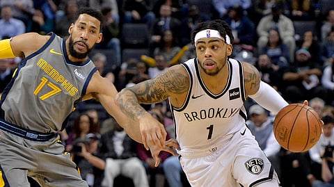 Brooklyn Nets guard D’Angelo Russell (1) drives past Memphis Grizzlies guard Garrett Temple (17) during the second half of an NBA basketball game Friday, Jan. 4, 2019, in Memphis, Tenn. (AP Photo/Brandon Dill)