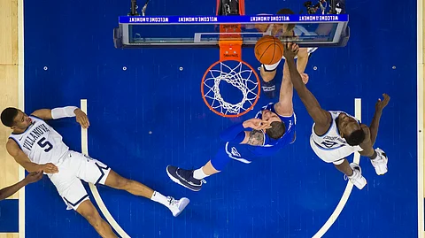 In this January 2019 file photo, Seton Hall’s Sandro Mamukelashvili, center, puts up the shot against Villanova’s Dhamir Cosby-Roundtree, right, as Phil Booth, left, looks on from the court during the first half of an NCAA college basketball game in Philadelphia.