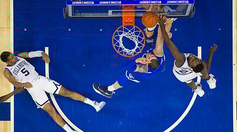 Seton Hall’s Sandro Mamukelashvili, center, puts up the shot against Villanova’s Dhamir Cosby-Roundtree, right, as Phil Booth, left, looks on from the court during the first half of an NCAA college basketball game, Sunday, Jan. 27, 2019, in Philadelphia. (AP Photo/Chris Szagola)