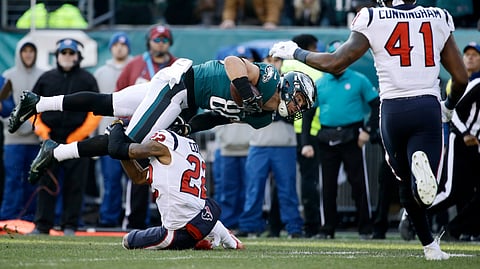 Philadelphia Eagles’ Zach Ertz (86) is tackled by Houston Texans’ Aaron Colvin (22) as Zach Cunningham (41) runs in during the first half of an NFL football game, Sunday, Dec. 23, 2018, in Philadelphia. (AP Photo/Matt Rourke)