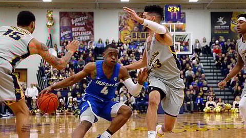 Buffalo guard Davonta Jordan (4) drives against Canisius guard Isaiah Reese (13) during the first half of an NCAA college Basketball game, Saturday, Dec. 29, 2018, in Buffalo N.Y. (AP Photo/Jeffrey T. Barnes)