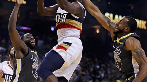 New Orleans Pelicans’ Jrue Holiday, center, is fouled by Golden State Warriors’ Andre Iguodala, right, during the first half of an NBA basketball game Wednesday, Jan. 16, 2019, in Oakland, Calif. (AP Photo/Ben Margot)