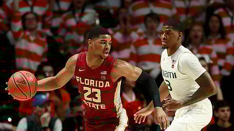 Florida State guard M.J. Walker (23) looks for an opening past Miami guard Anthony Lawrence II (3) during the first half of an NCAA college basketball game, Sunday, Jan. 27, 2019, in Coral Gables, Fla. (AP Photo/Wilfredo Lee)