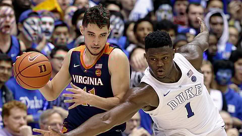 Duke’s Zion Williamson (1) tries to steal the ball from Virginia’s Ty Jerome during the second half of an NCAA college basketball game in Durham, N.C., Saturday, Jan. 19, 2019. Duke won 72-70. (AP Photo/Gerry Broome)