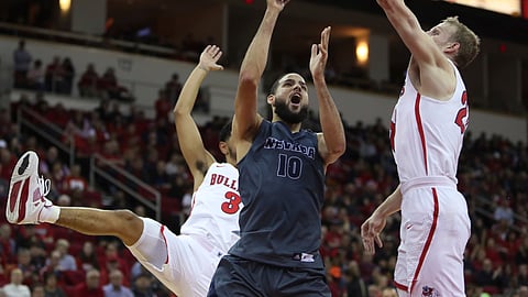 Nevada’s Caleb Martin (10) tries to shoot over Fresno State’s Sam Bittner, right, during the first half of an NCAA college basketball game in Fresno, Calif., Saturday, Jan. 12, 2019. (AP Photo/Gary Kazanjian)