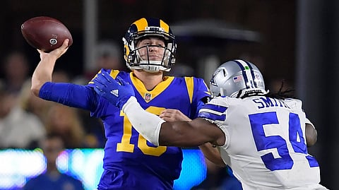 Los Angeles Rams quarterback Jared Goff passes under pressure from Dallas Cowboys middle linebacker Jaylon Smith during the first half in an NFL divisional football playoff game Saturday, Jan. 12, 2019, in Los Angeles. (AP Photo/Mark J. Terrill)