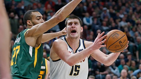 Utah Jazz center Rudy Gobert (27) defends against Denver Nuggets center Nikola Jokic.
