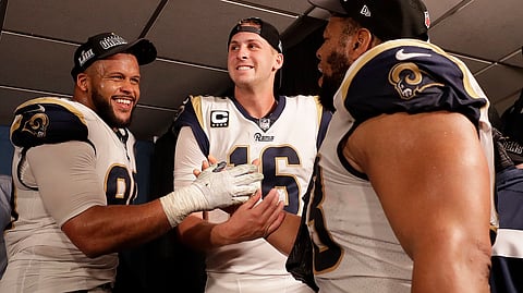 Los Angeles Rams defensive end Aaron Donald (99) Los Angeles Rams nose tackle Ndamukong Suh (93) and Los Angeles Rams quarterback Jared Goff (16) after overtime of the NFL football NFC championship game against the New Orleans Saints, Sunday, Jan. 20, 2019, in New Orleans. The Rams won 26-23.(AP Photo/David J. Phillip)
