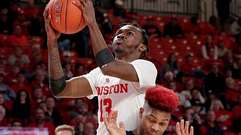 Houston guard Dejon Jarreau (13) puts up a shot over Utah State guard John Knight III (3) during the first half of an NCAA college basketball game Thursday, Dec. 20, 2018, in Houston. (AP Photo/Michael Wyke)