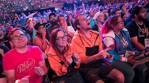 FILE - In this July 28, 2018 file photo, Philadelphia Fusion fans react as the London Spitfire takes the lead during the Overwatch League Grand Finals competition at Barclays Center in the Brooklyn borough of New York. Most professional esports are devoid of female players at their highest levels, even though 45 percent of U.S. gamers are women or girls. Executives for titles like League of Legends and Overwatch say they are eager to add women to pro rosters, but many female gamers say they’re discouraged from chasing such careers by toxic behavior and other barriers. (AP Photo/Mary Altaffer, File)