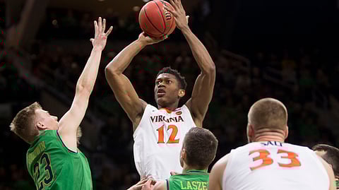 Virginia’s De’Andre Hunter (12) goes up for a shot over Notre Dame’s Dane Goodwin (23) and Nate Laszewski during the first half of an NCAA college basketball game Saturday, Jan. 26, 2019, in South Bend, Ind. (AP Photo/Robert Franklin)