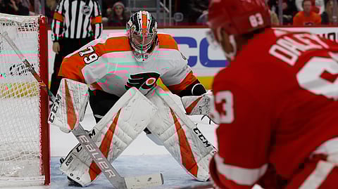 Detroit Red Wings defenseman Trevor Daley (83) shoots towards Philadelphia Flyers goaltender Carter Hart (79), Sunday, Feb. 17, 2019, in Detroit. (AP Photo/Carlos Osorio)