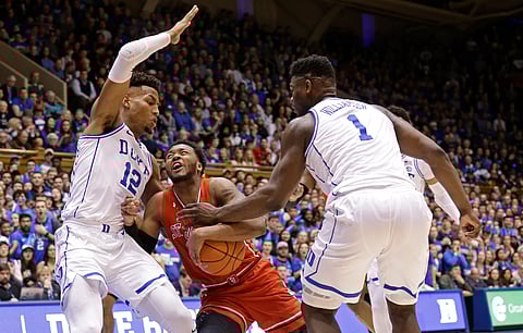 Duke’s Javin DeLaurier (12) and Zion Williamson (1) defend against St. John’s Shamorie Ponds last Saturday