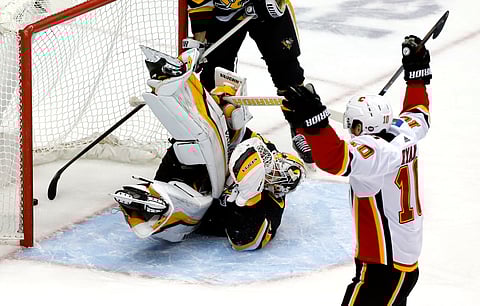 Flames’ Derek Ryan celebrates over allen Penguins goaltender Matt Murray Saturday