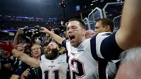 New England Patriots’ Julian Edelman, left, and Tom Brady celebrate after the NFL Super Bowl 53 football game against the Los Angeles Rams, Sunday, Feb. 3, 2019, in Atlanta. The Patriots won 13-3. Edelman was named the Most Valuable Player. (AP Photo/David J. Phillip)