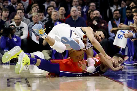 Sixers’ Ben Simmonds battles the Nuggets’ Jamal Murray for a loose ball last week
