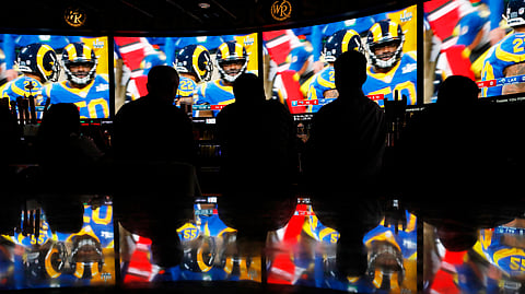 People watch Super Bowl LIII at the Westgate Superbook sports book, Sunday, Feb. 3, 2019, in Las Vegas. (AP Photo/John Locher)