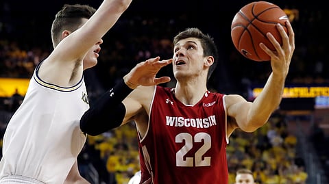 Wisconsin forward Ethan Happ (22) looks to shoot as Michigan center Jon Teske defends Saturday, Feb. 9, 2019, in Ann Arbor, Mich. (AP Photo/Carlos Osorio)