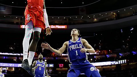 Landry Shamet looks on helplessly as Houston’s James Ennis III is about to send one down