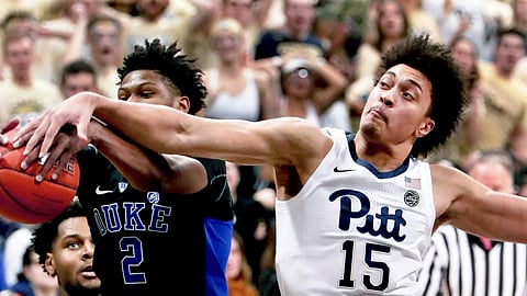 Pittsburgh’s Kene Chukwuka (15) and Duke’s Cam Reddish (2) vie for s rebound during the first half of an NCAA college basketball game, Tuesday, Jan. 22, 2019, in Pittsburgh. (AP Photo/Keith Srakocic)