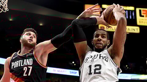 San Antonio Spurs center LaMarcus Aldridge, right, grabs a rebound in front of Portland Trail Blazers center Jusuf Nurkic during the first half of an NBA basketball game in Portland, Ore., Thursday, Feb. 7, 2019. (AP Photo/Steve Dykes)