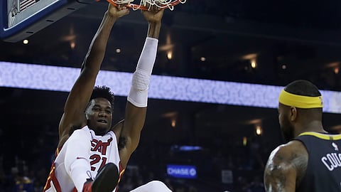 Miami Heat center Hassan Whiteside, left, scores against the Golden State Warriors’ , Sunday, Feb. 10, 2019, in Oakland, Calif. (AP Photo/Ben Margot)