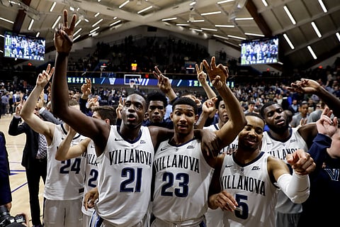 Dhamir Cosby-Roundtree (21), Jermaine Samuels (23) and Phil Booth (5) celebrate Villanova’s victory Wednesday