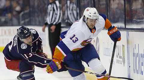 New York Islanders’ Mathew Barzal carries the puck as Columbus Blue Jackets’ Cam Atkinson defends, Thursday, Feb. 14, 2019, in Columbus, Ohio. (AP Photo/Jay LaPrete)
