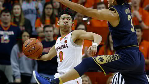 Virginia guard Kihei Clark tries to get the ball down court as Notre Dame guard Prentiss Hubb defends. (AP Photo/Steve Helber)