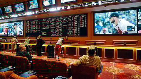 FILE - In this May 14, 2018, file photo, people make bets in the sports book at the South Point hotel and casino in Las Vegas. Las Vegas is not worried about the competition from casinos in other states that for the first time Sunday, Feb. 3, 2019, will also offer football fans a chance to bet on the Super Bowl. The weekend is worth hundreds of millions of dollars to the city, which draws tens of thousands of people for the big game’s weekend. (AP Photo/John Locher, File)