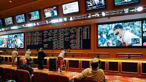 People make bets in the sports book at the South Point hotel and casino in Las Vegas. (AP Photo/John Locher, File)