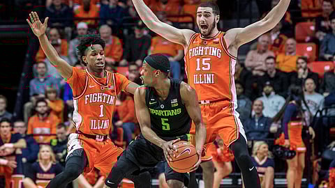 In this February 2019 file photo, Illinois’ Trent Frazier (1) and Giorgi Bezhanishvili (15) pressure Michigan State’s Cassius Winston (5) in Champaign, Ill.