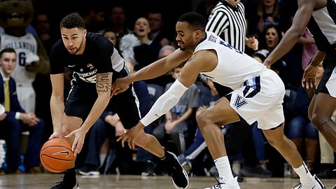 Villanova’s Phil Booth (right) and Providence’s Drew Edwards chase down a loose ball Wednesday
