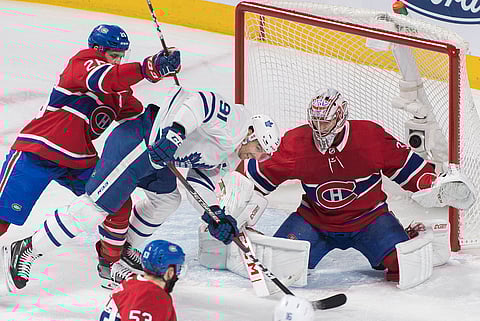 Maple Leafs’ John Tavares battles Blackhawks goalie Carey Price and Jeff Petry in early February (Graham Hughes/Canadian Press)