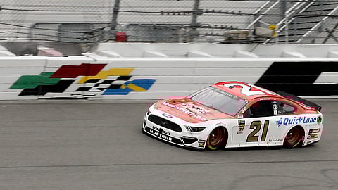 Paul Menard (21) leads the NASCAR Clash auto race on lap seven just before rain delayed the race at Daytona International Speedway. (AP Photo/Terry Renna)