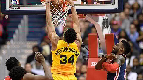 Milwaukee Bucks forward Giannis Antetokounmpo (34) dunks against Washington Wizards forward Jeff Green, right, during the first half of an NBA basketball game, Saturday, Feb. 2, 2019, in Washington. Green was called for a foul on the play. (AP Photo/Nick Wass)