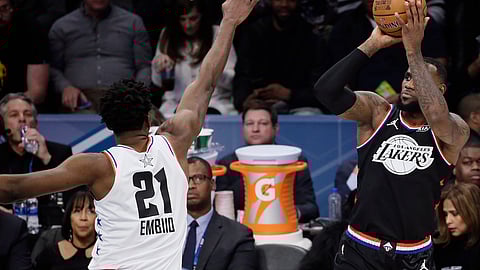 Lakers’ LeBron James shoots over the Sixers’ Joel Embiid in the All-Star Game Sunday