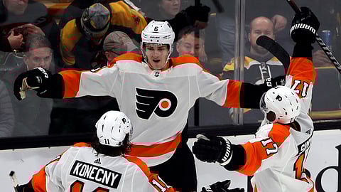 Philadelphia Flyers defenseman Travis Sanheim (6) celebrates his winning goal with teammates Travis Konecny (11) and Wayne Simmonds (17) in the overtime period of an NHL hockey game against the Boston Bruins, Thursday, Jan. 31, 2019, in Boston. (AP Photo/Elise Amendola)