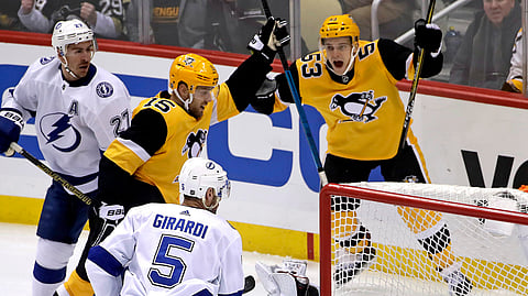 Pittsburgh Penguins’ Riley Sheahan (15) celebrates his goal past sprawling Tampa Bay Lightning goaltender Andrei Vasilevskiy (88) with Teddy Blueger (53) during the first period of an NHL hockey game in Pittsburgh, Wednesday, Jan. 30, 2019. (AP Photo/Gene J. Puskar)