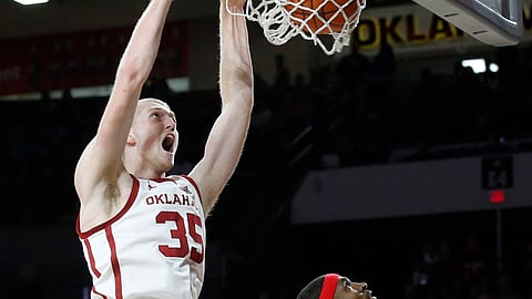 Oklahoma forward Brady Manek, left, dunks on Texas Tech in a game in Norman, Okla., Saturday, Feb. 9, 2019. (AP Photo/Sue Ogrocki)