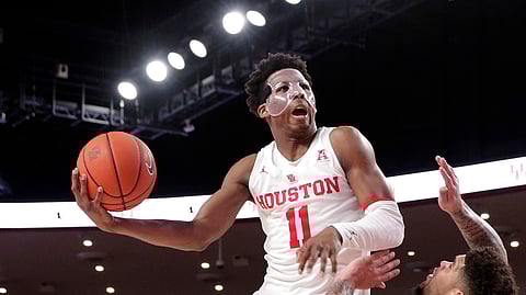 Houston guard Nate Hinton (11) jumps to shoot over Cincinnati guard Jarron Cumberland (34) Feb. 10, 2019, in Houston. (AP Photo/Michael Wyke)