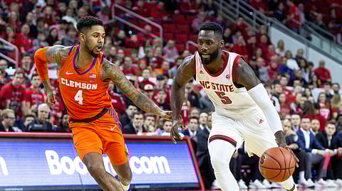 NC State’s Eric Lockett drives against Clemson’s Shelton Mitchell