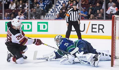 New Jersey’s Damon Severson scores against Vancouver goalie Jacob Markstrom to complete a shooutout victory Friday ((Darryl Dyck/The Canadian Press)
