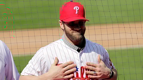 Bryce Harper smiles after putting on a Philadelphia Phillies jersey during a news conference at the team’s spring training baseball facility, Saturday, March 2, 2019. (Lynne Sladky)